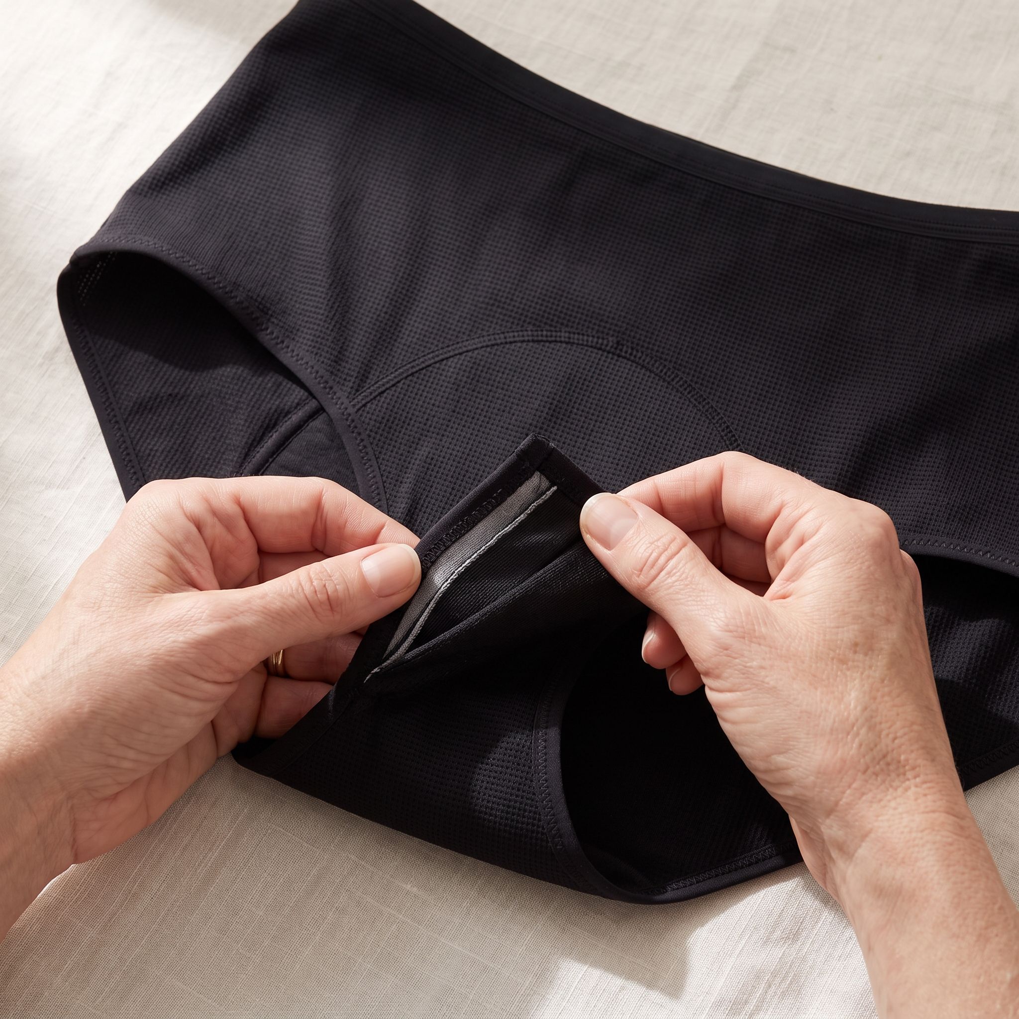Most leakproof underwear absorbs. The third layer is what seals.