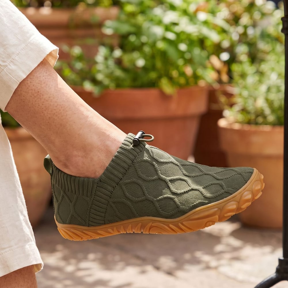 Woman at a cafe wearing olive StrideFlex Wide shoes
